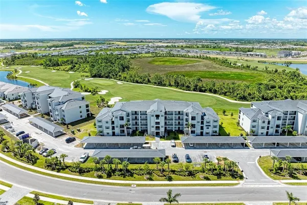 a view of a garden with a bench in front of house