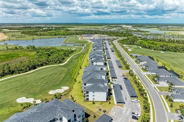 a view of a garden with a bench in front of house