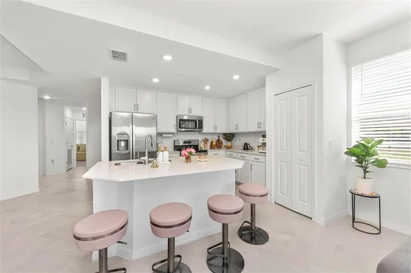 a kitchen with a sink stove and cabinets