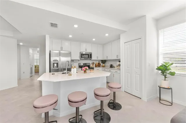 a kitchen with a sink stove and cabinets