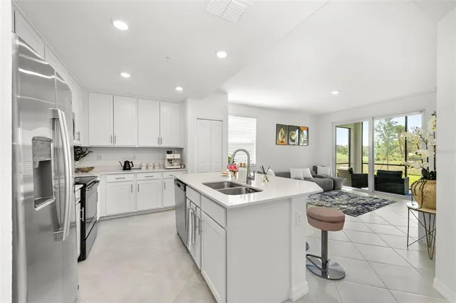 a living room with stainless steel appliances kitchen island furniture and a view of kitchen