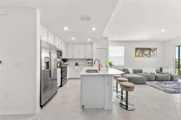 a kitchen with a sink a stove and refrigerator