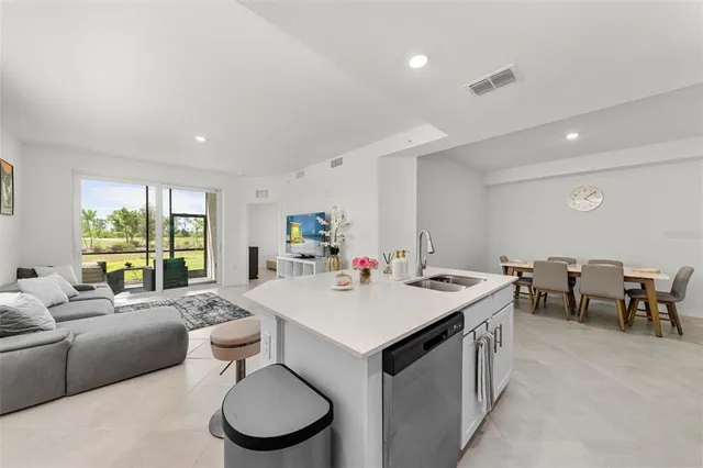 a living room with furniture and painting on the wall