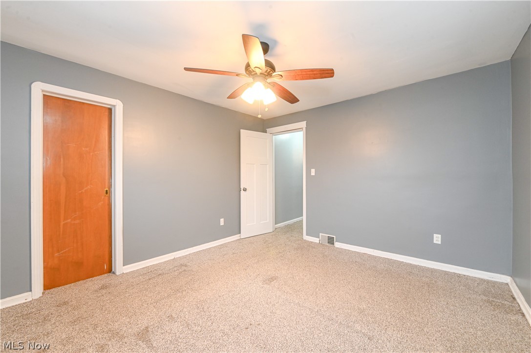 8301 Ackley Road Parma, OH 44129 - Photo 25 of 47 Carpeted empty room with ceiling fan