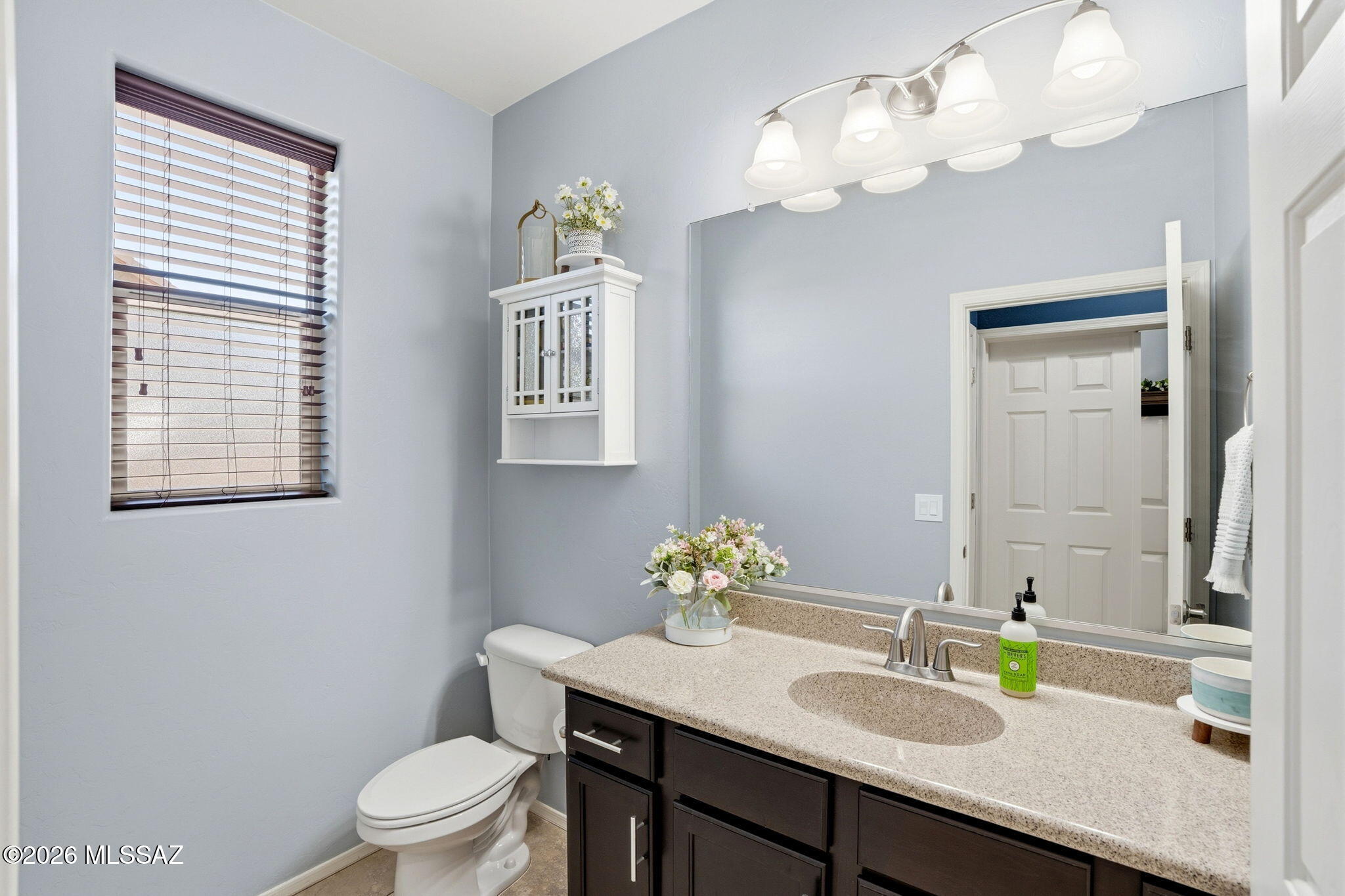 211 East Refuge Loop Vail, AZ 85641 - Photo 14 of 48 a bathroom with a sink a toilet and a mirror