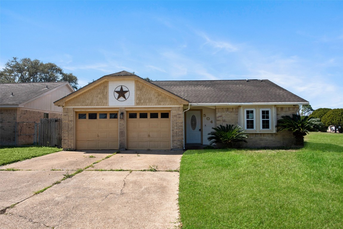 a front view of a house with a garden and yard