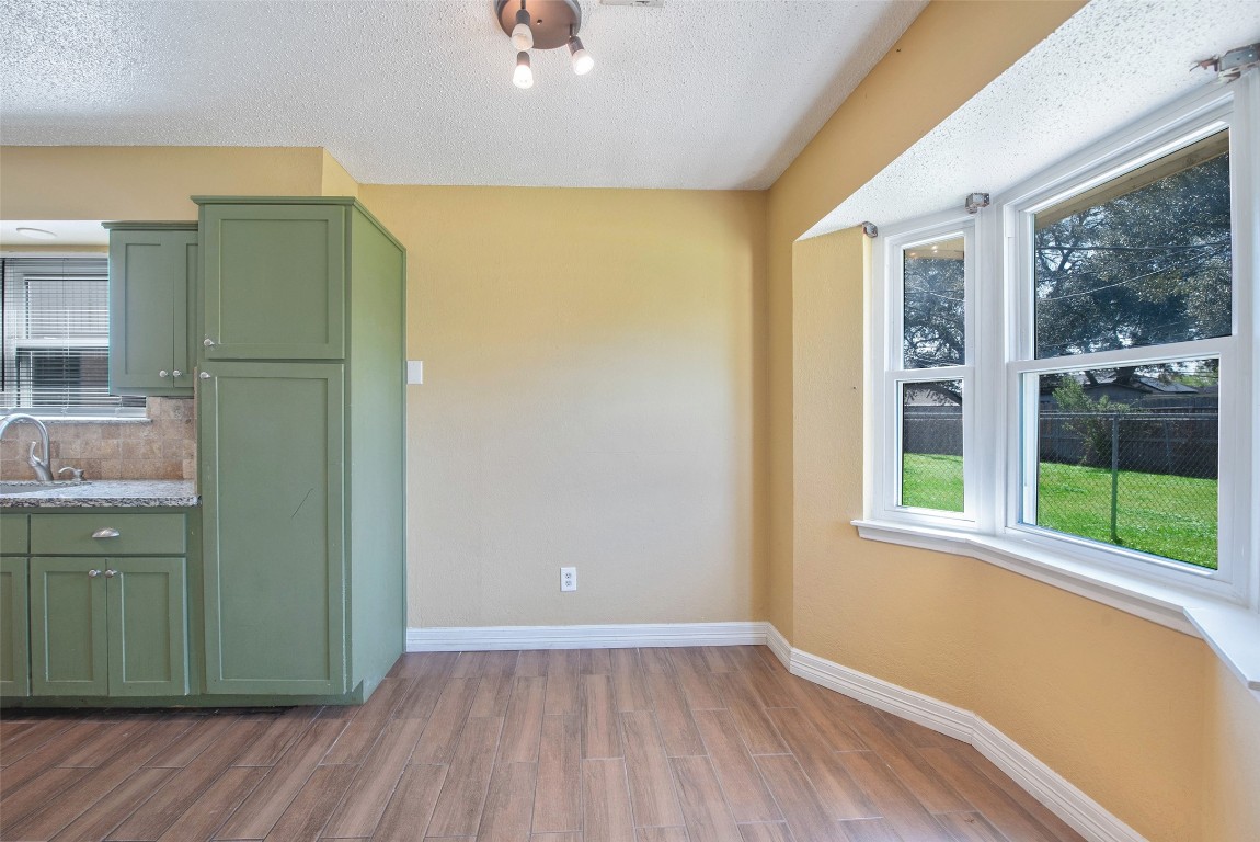 504 Raymond Street La Marque, TX 77568 - Photo 11 of 22 an empty room with wooden floor and a window