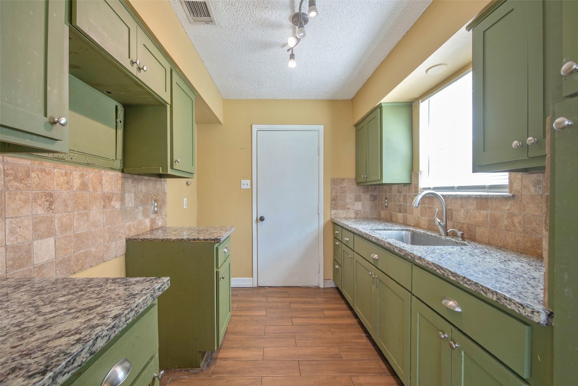 504 Raymond Street La Marque, TX 77568 - Photo 12 of 22 a bathroom with a granite countertop sink and a mirror