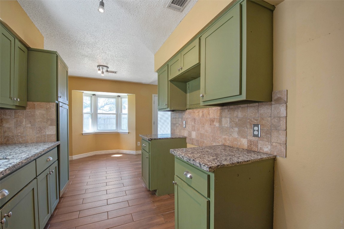 504 Raymond Street La Marque, TX 77568 - Photo 14 of 22 a kitchen with a sink cabinets and wooden floor