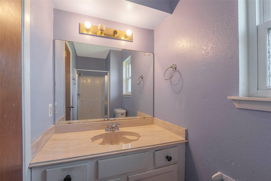 504 Raymond Street La Marque, TX 77568 - Photo 19 of 22 a bathroom with a sink and a mirror