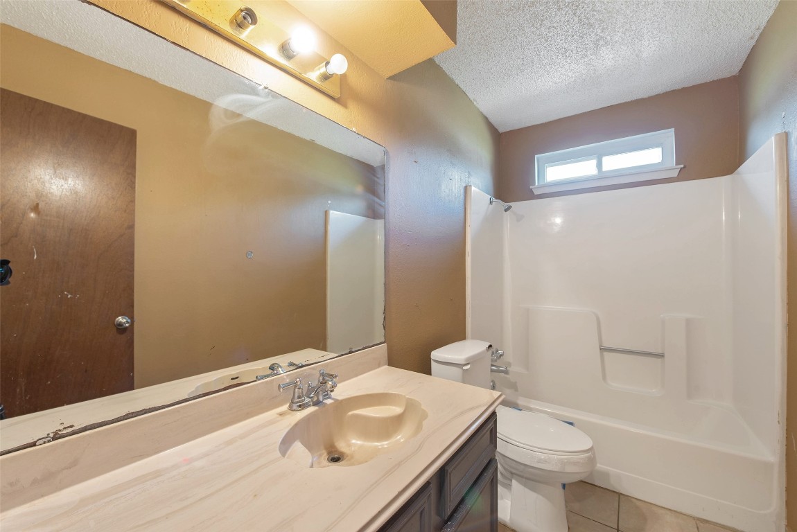 504 Raymond Street La Marque, TX 77568 - Photo 21 of 22 a bathroom with a sink a toilet and shower