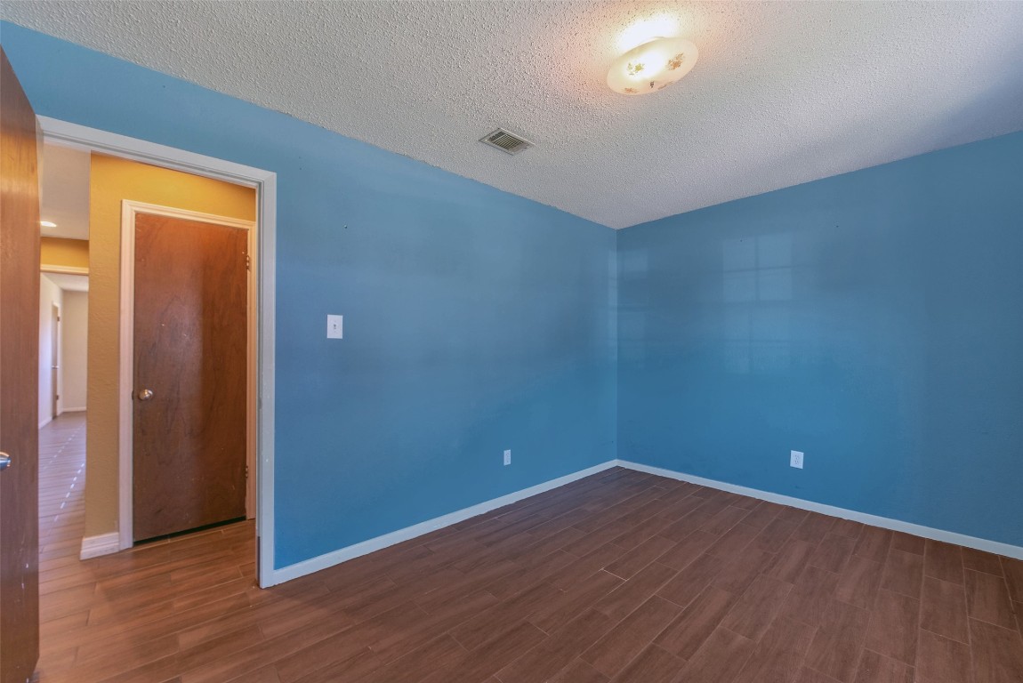 504 Raymond Street La Marque, TX 77568 - Photo 22 of 22 a view of an empty room with wooden floor and a window