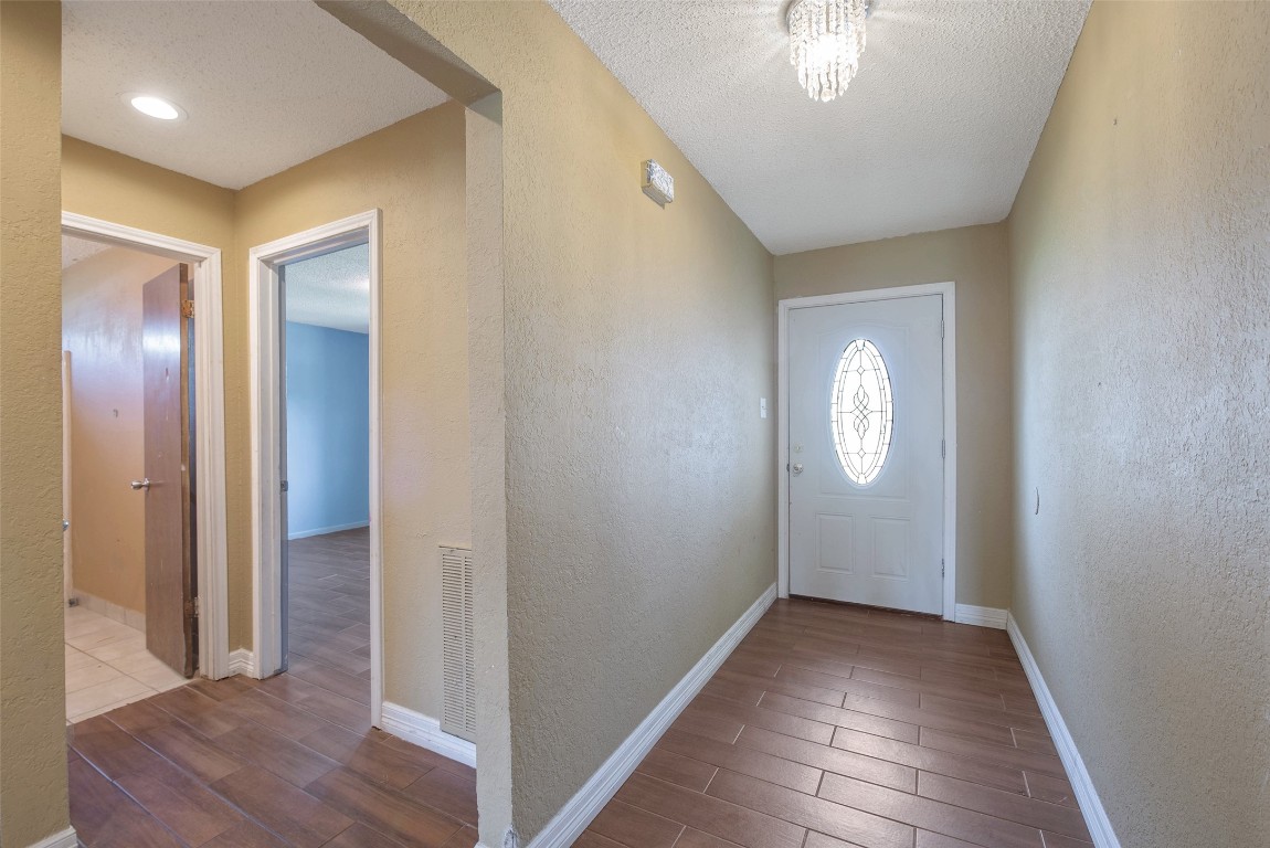 504 Raymond Street La Marque, TX 77568 - Photo 6 of 22 a view of a hallway with wooden floor