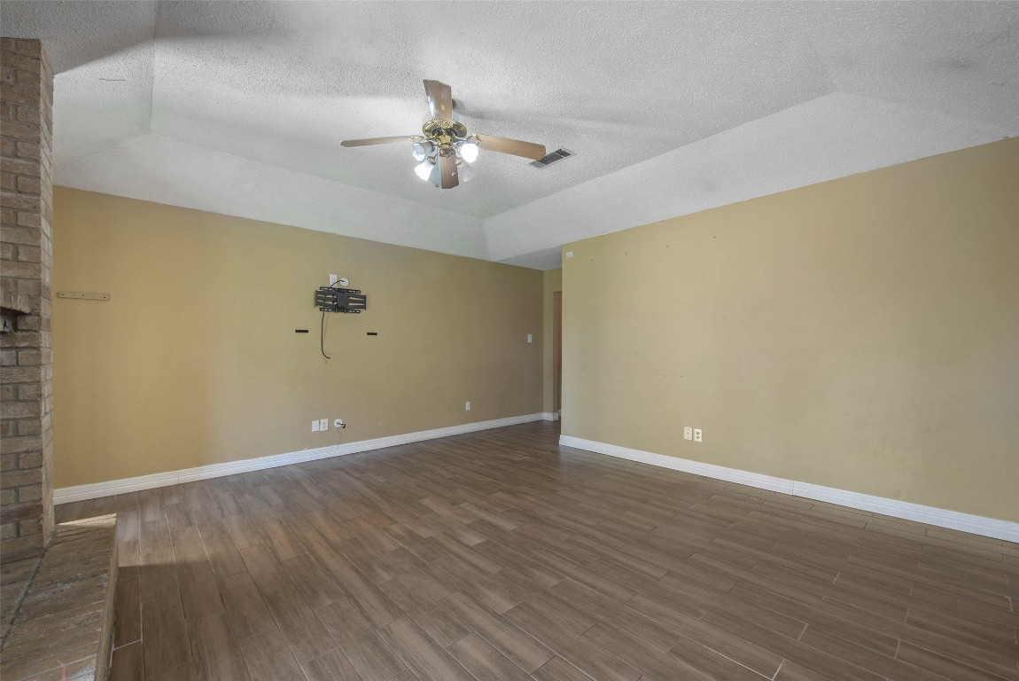 504 Raymond Street La Marque, TX 77568 - Photo 9 of 22 a view of an empty room with wooden floor