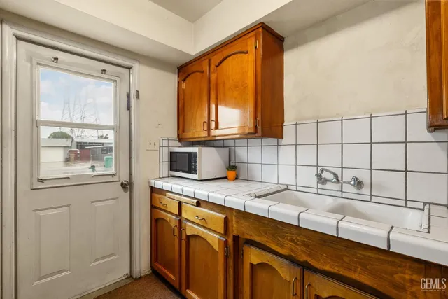 a kitchen with stainless steel appliances a sink a stove and cabinets