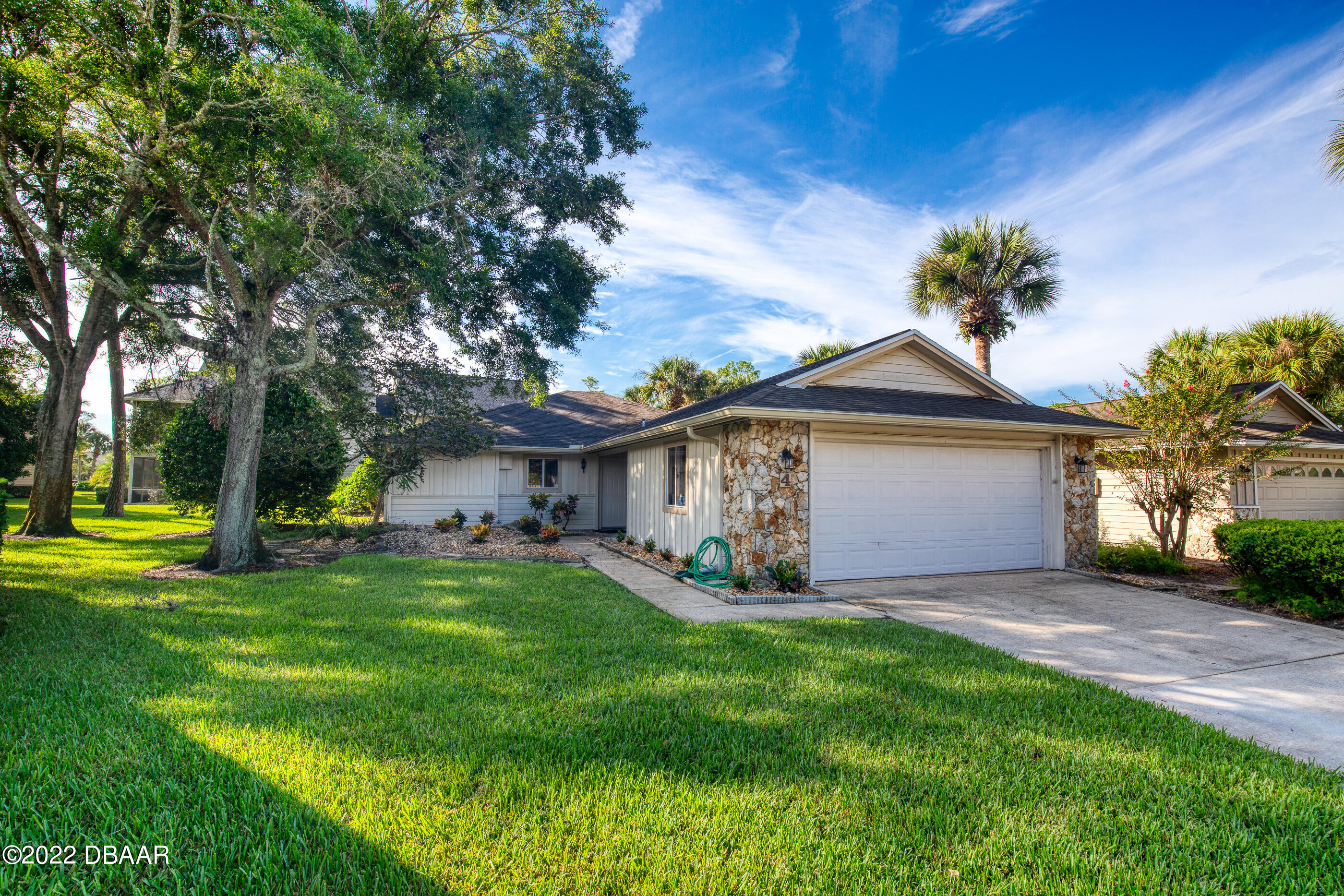 a view of a house with a yard and tree s
