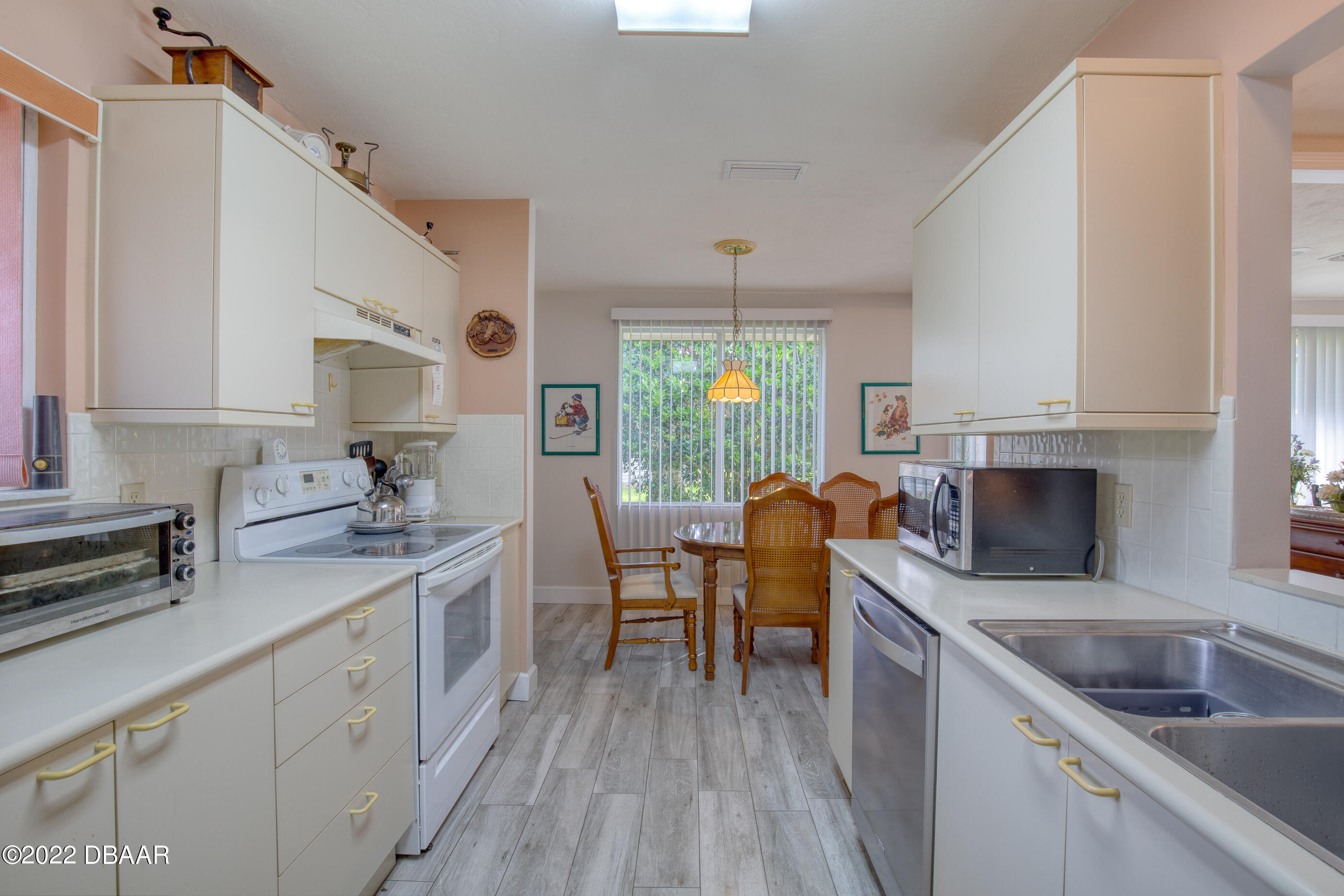 4 Jasmine Run Ormond Beach, FL 32174 - Photo 11 of 18 a kitchen with a sink stove and cabinets
