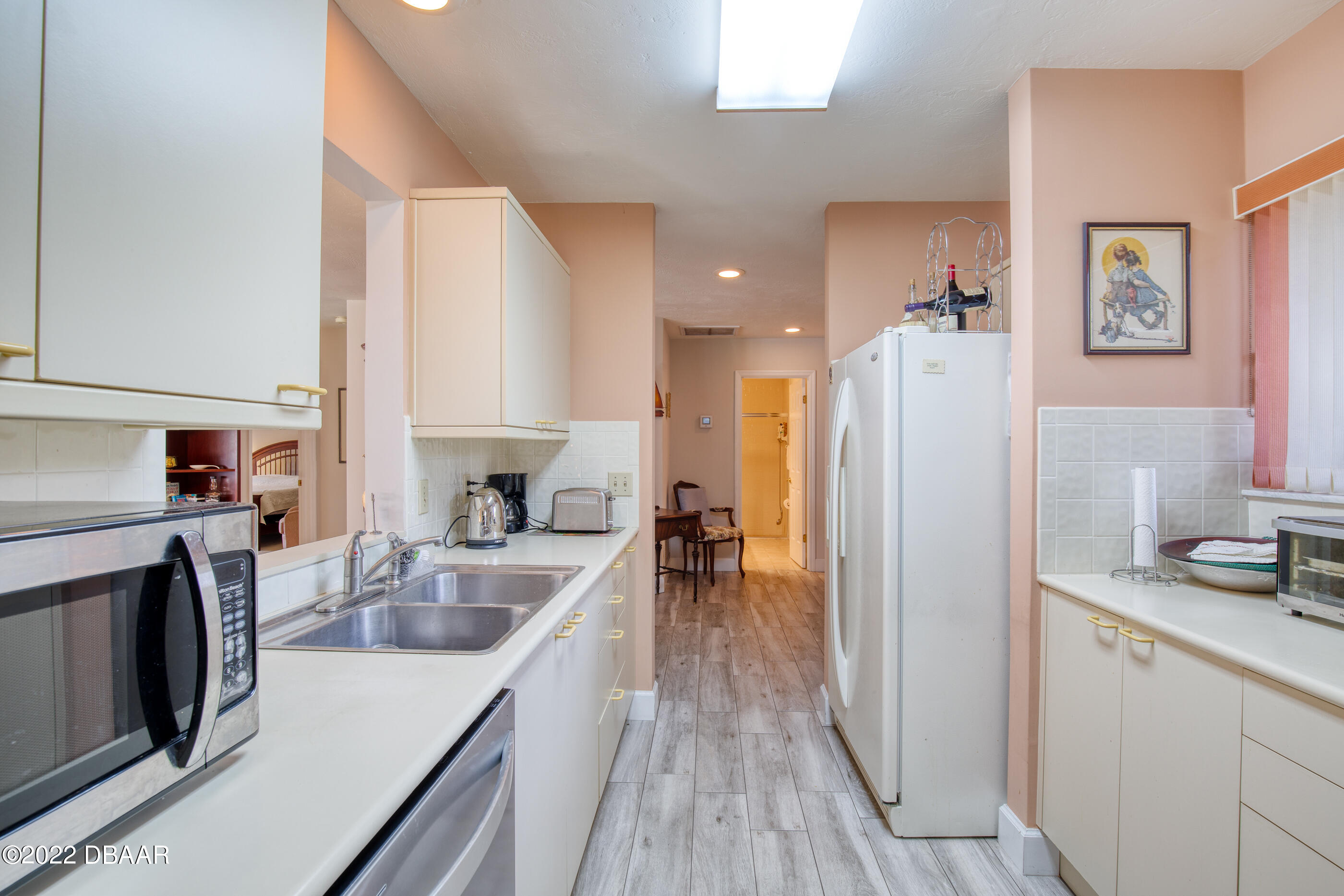 4 Jasmine Run Ormond Beach, FL 32174 - Photo 12 of 18 a kitchen with a refrigerator a oven a sink a counter space and cabinets