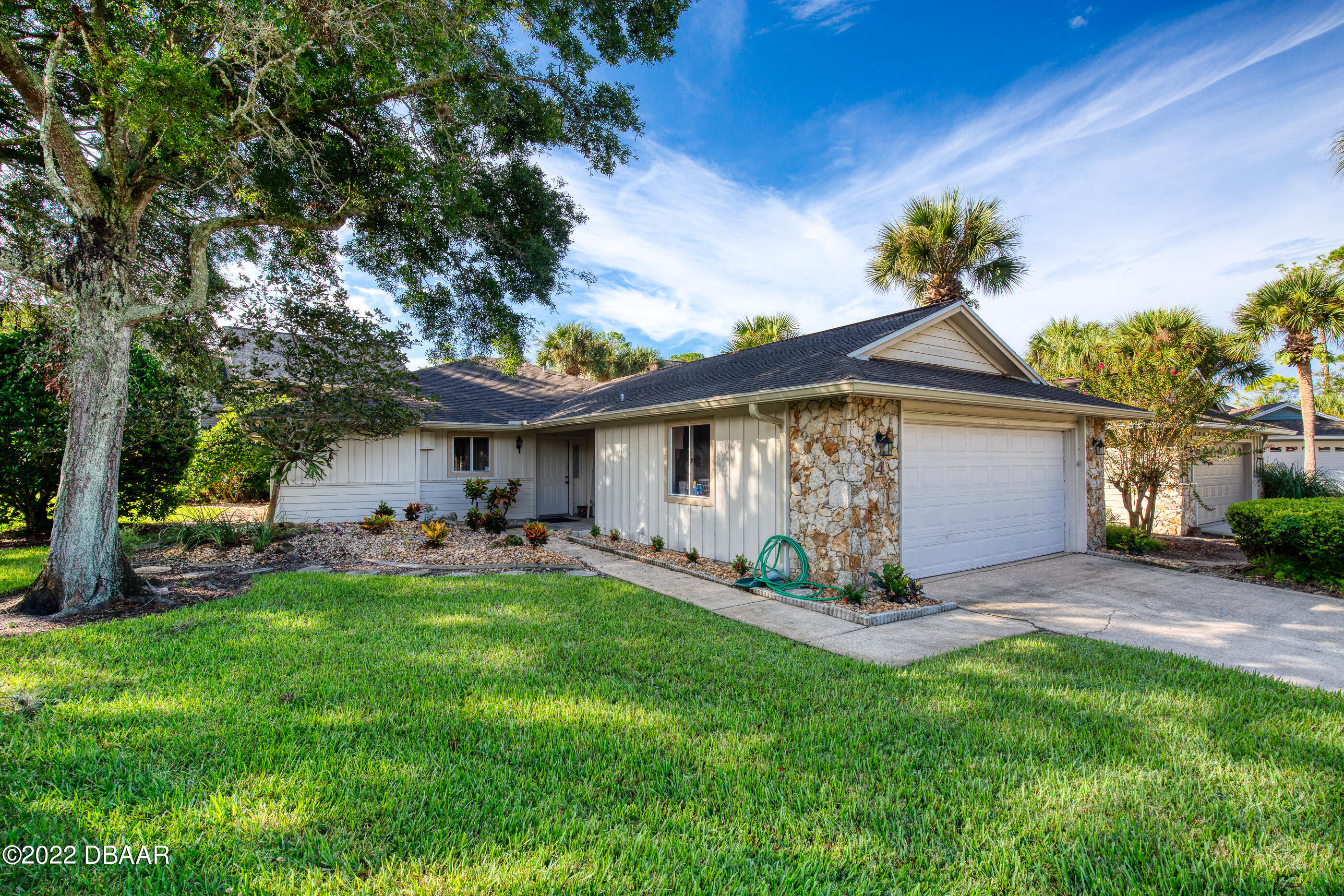 4 Jasmine Run Ormond Beach, FL 32174 - Photo 2 of 18 a view of a chair and table in back yard of the house