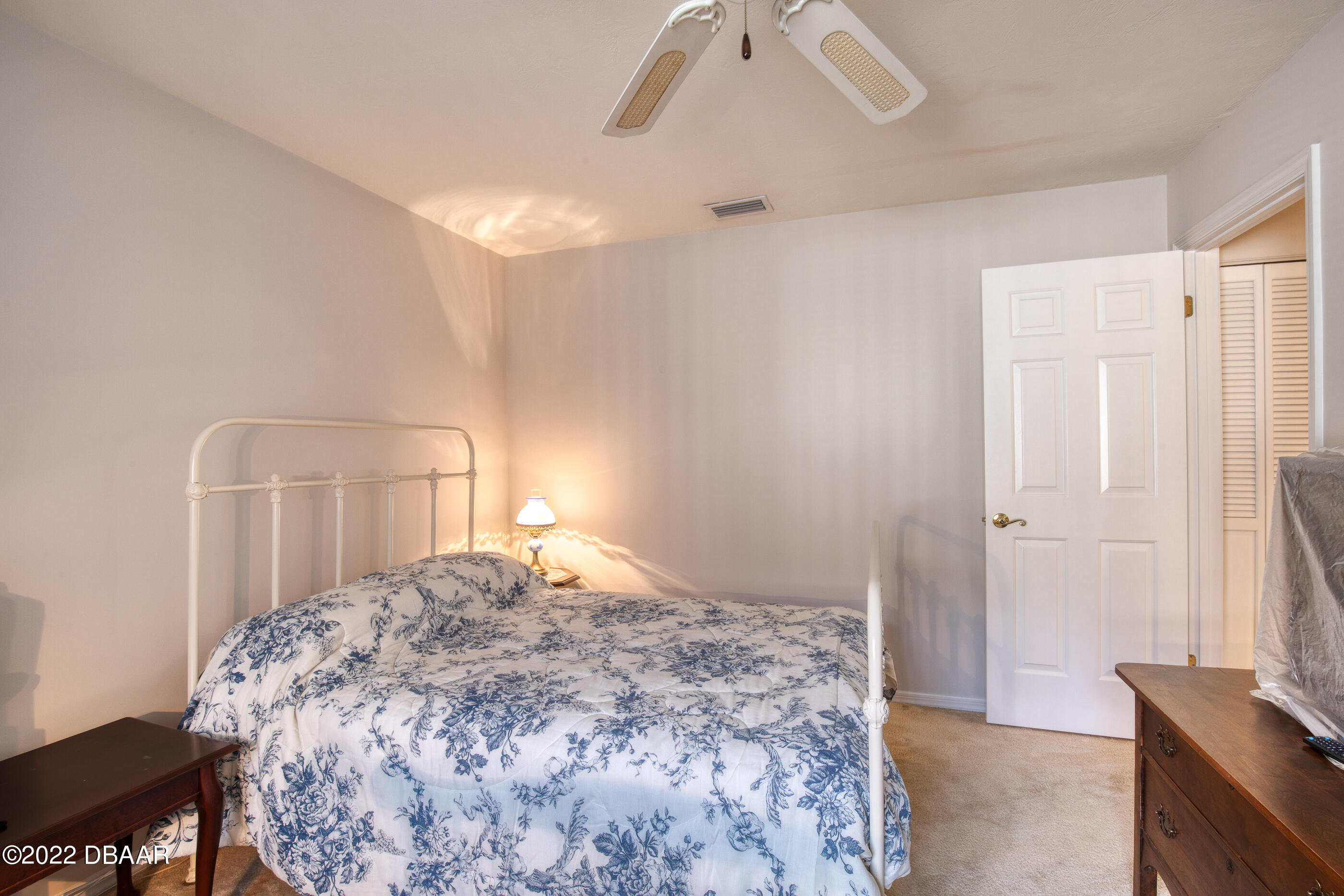 4 Jasmine Run Ormond Beach, FL 32174 - Photo 9 of 18 a bedroom with a bed and a cabinets