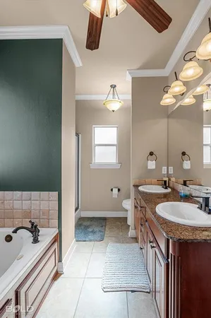 a spacious bathroom with a granite countertop sink a mirror and bathtub