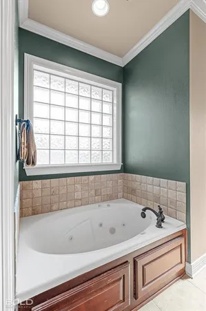 a bathroom with a bathtub and next to a window