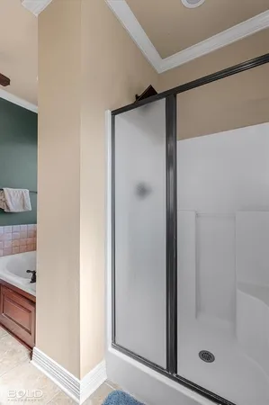 a bathroom with a glass shower door