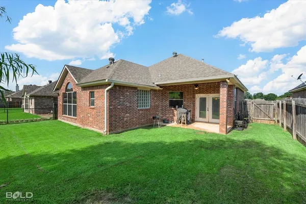 a view of a house with a yard and sitting area