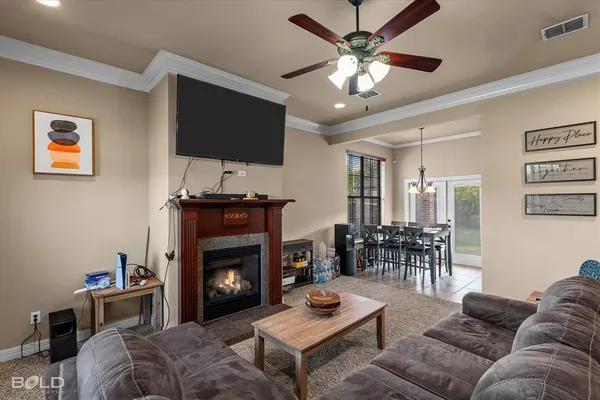 a living room with furniture a flat screen tv and a fireplace