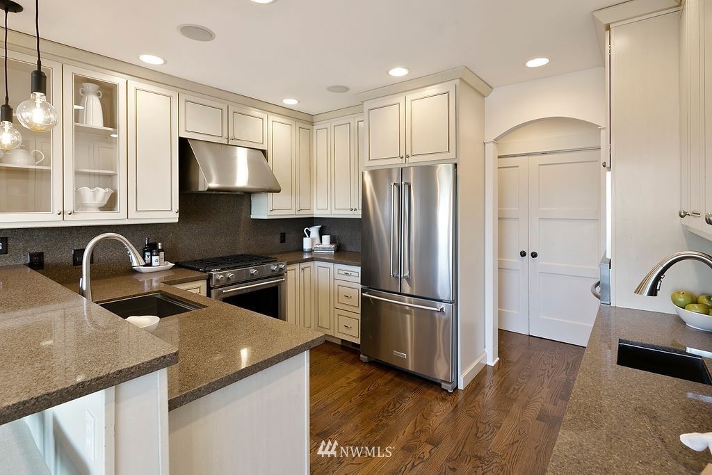 2801 28th Avenue West Seattle, WA 98199 - Photo 15 of 39 a kitchen with stainless steel appliances granite countertop a refrigerator a sink and a stove