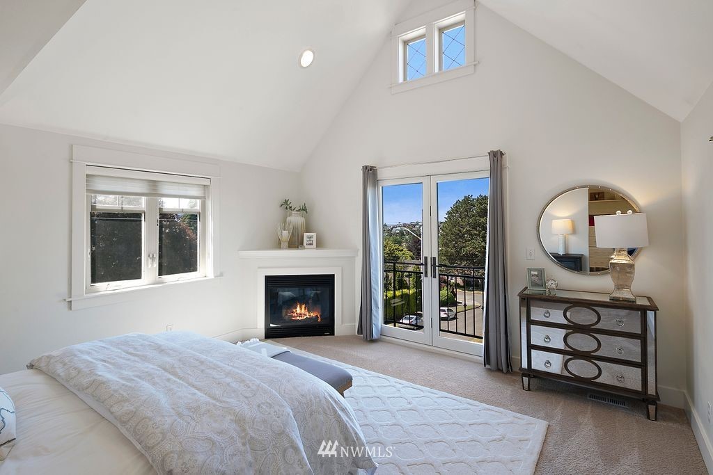 2801 28th Avenue West Seattle, WA 98199 - Photo 20 of 39 a bedroom with a bed a fireplace and a painting