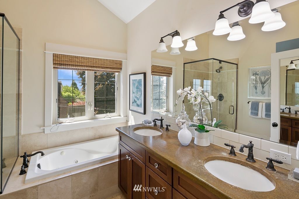 2801 28th Avenue West Seattle, WA 98199 - Photo 23 of 39 a bathroom with a tub double sink and a mirror