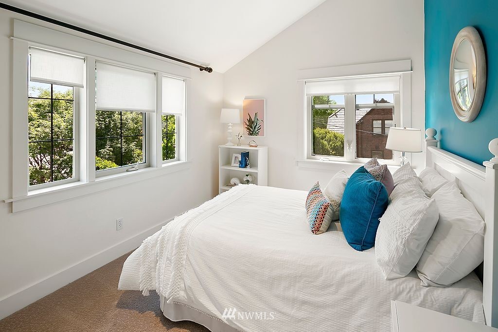 2801 28th Avenue West Seattle, WA 98199 - Photo 24 of 39 a bedroom with a bed mirror and window