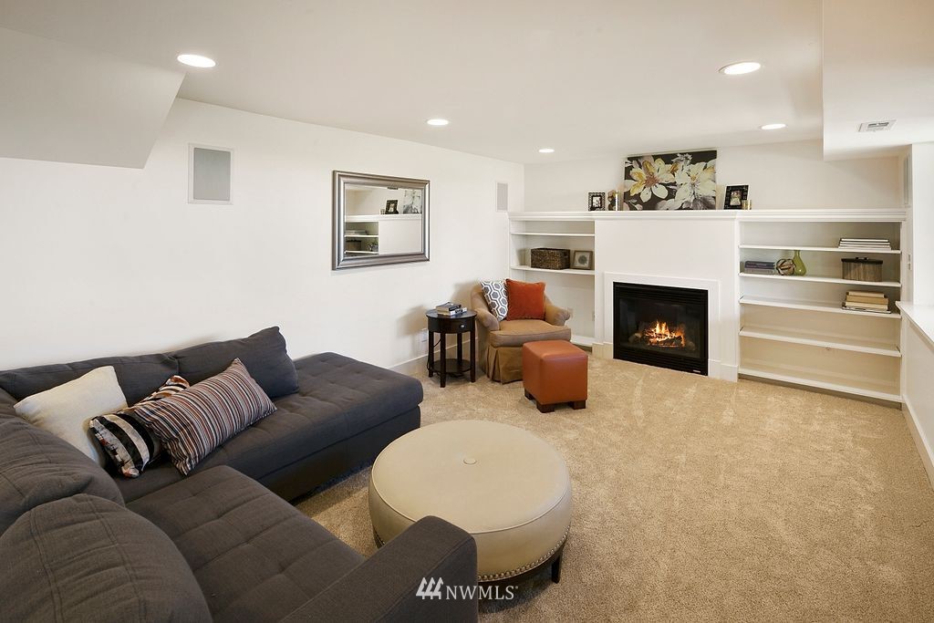 2801 28th Avenue West Seattle, WA 98199 - Photo 29 of 39 a living room with furniture and a fireplace