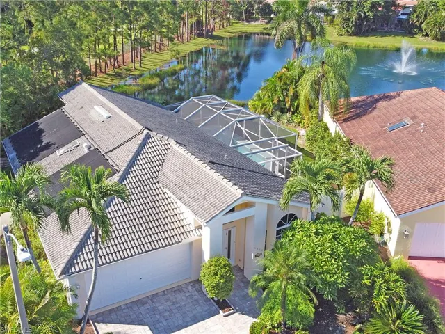 an aerial view of a house with garden space and lake view