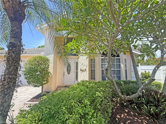 an aerial view of a house with a garden and lake view