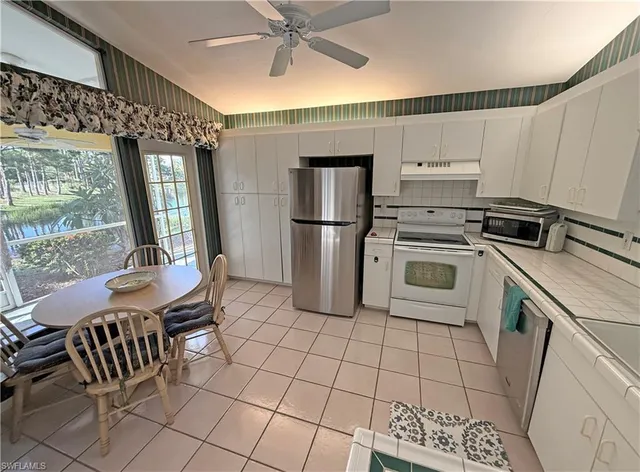 a kitchen with a sink cabinets and appliances