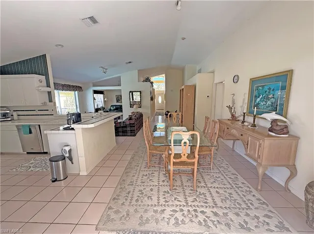 a living room with furniture a dining table and kitchen view