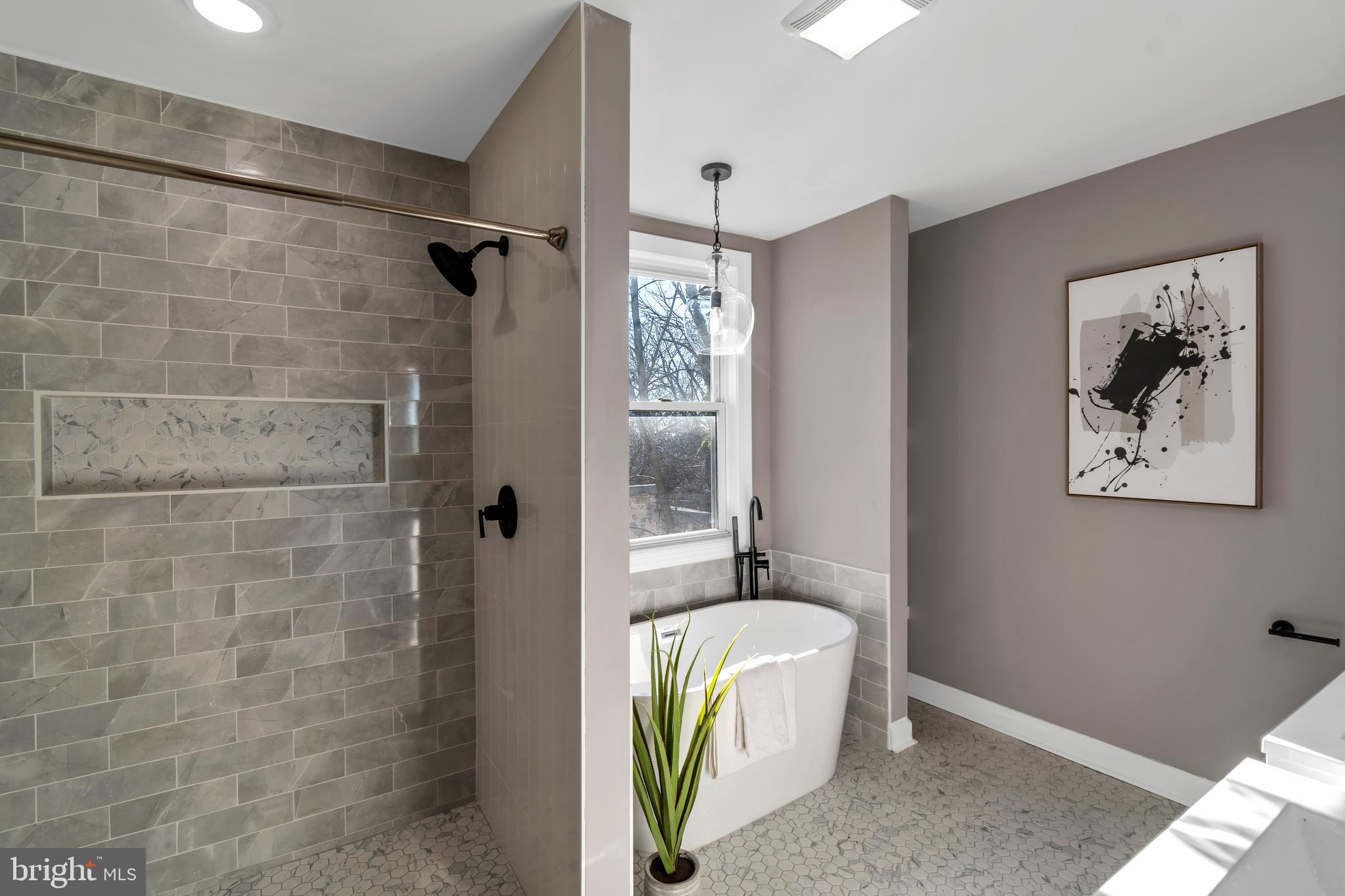 12 South Augusta Avenue Baltimore, MD 21229 - Photo 1 of 38 a bathroom with a tub a sink and glass door