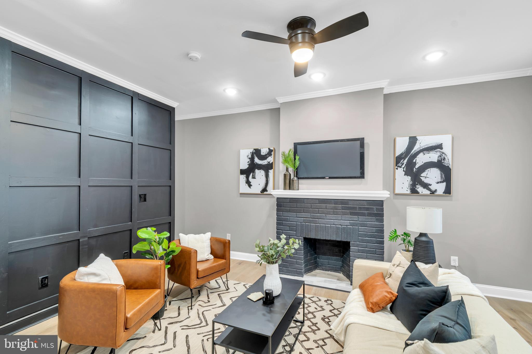 12 South Augusta Avenue Baltimore, MD 21229 - Photo 2 of 38 a living room with furniture a flat screen tv and a fireplace