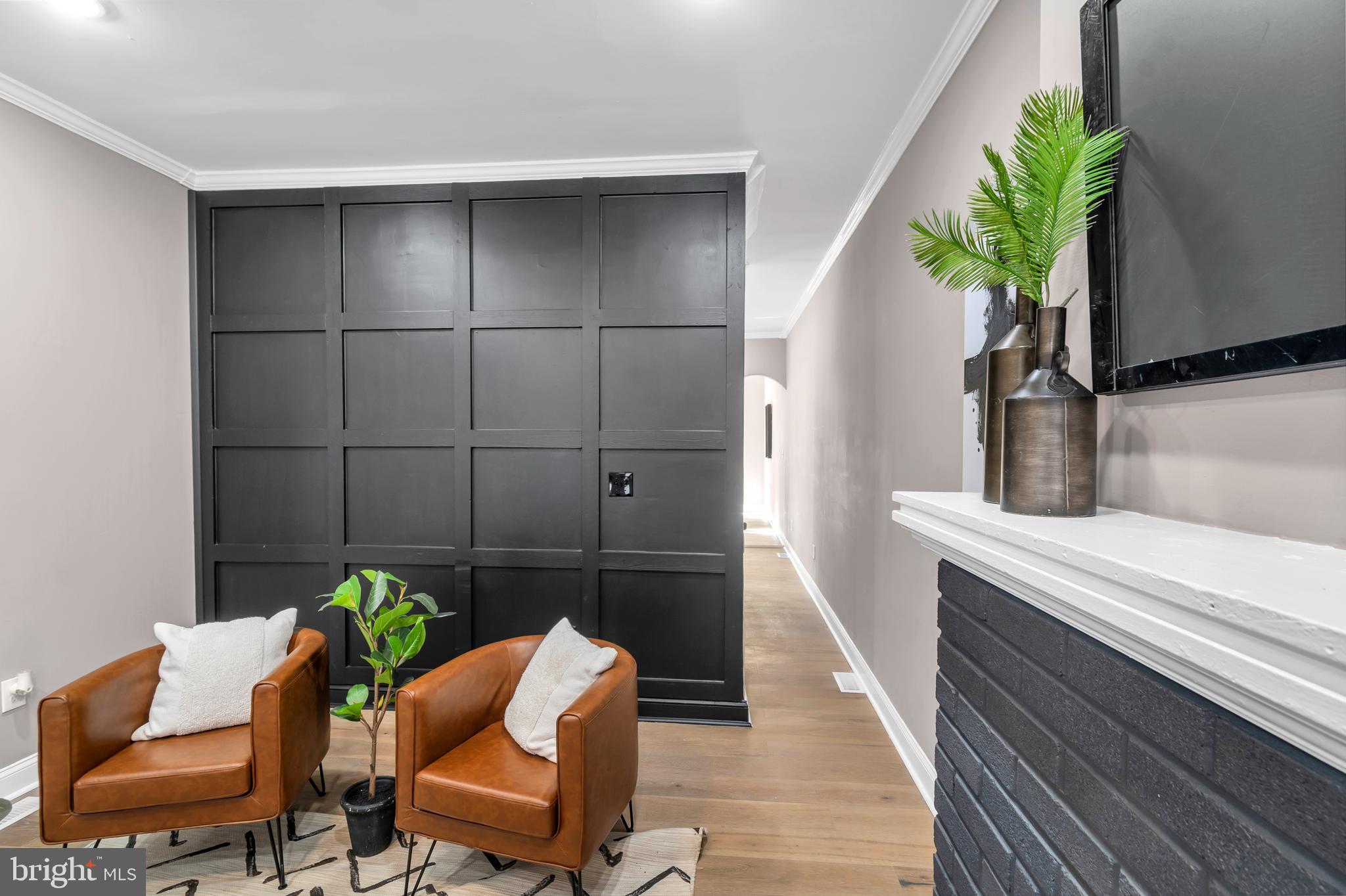 12 South Augusta Avenue Baltimore, MD 21229 - Photo 25 of 38 a hallway with a chair and a potted plant on a dresser