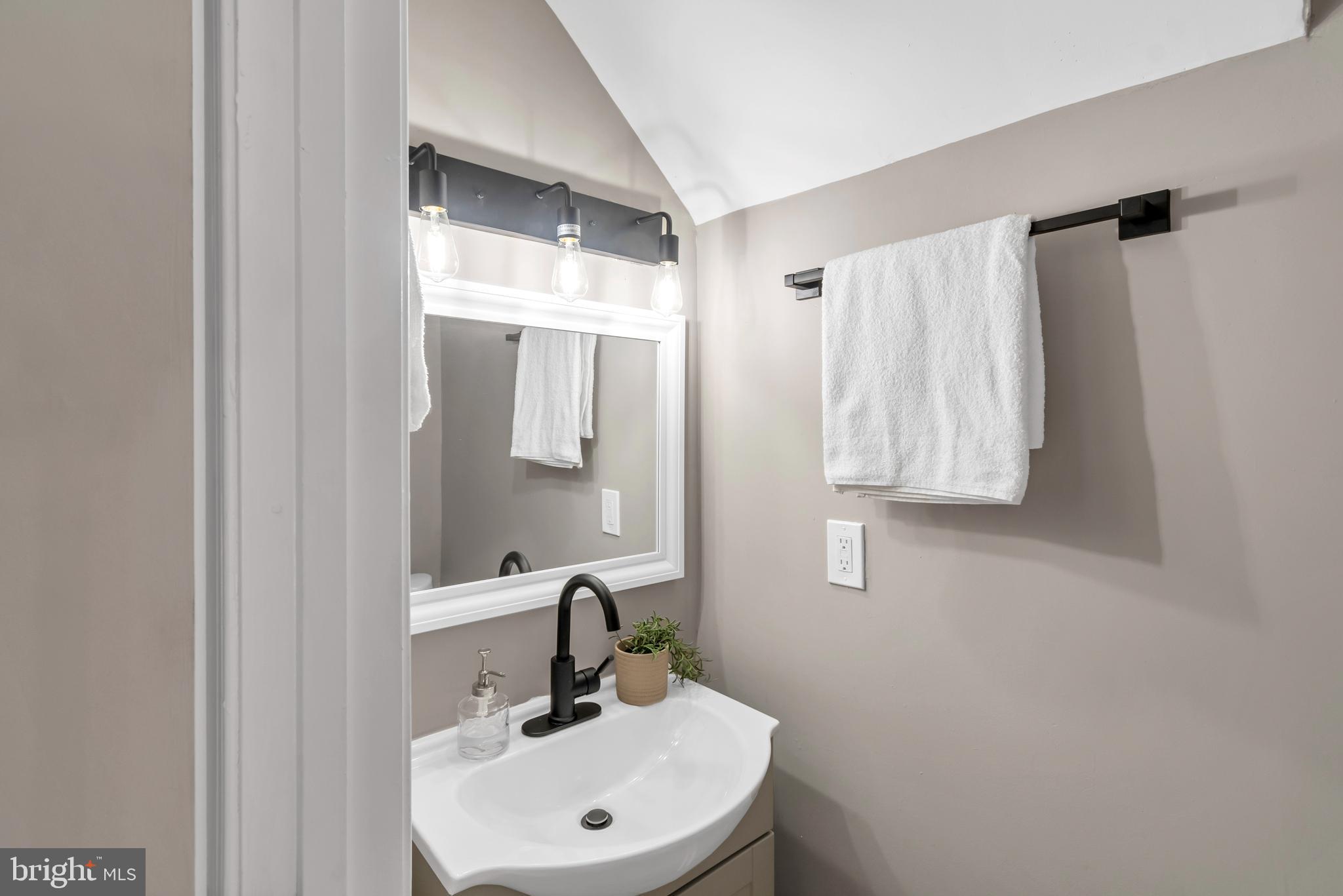 12 South Augusta Avenue Baltimore, MD 21229 - Photo 28 of 38 a bathroom with a sink and a mirror