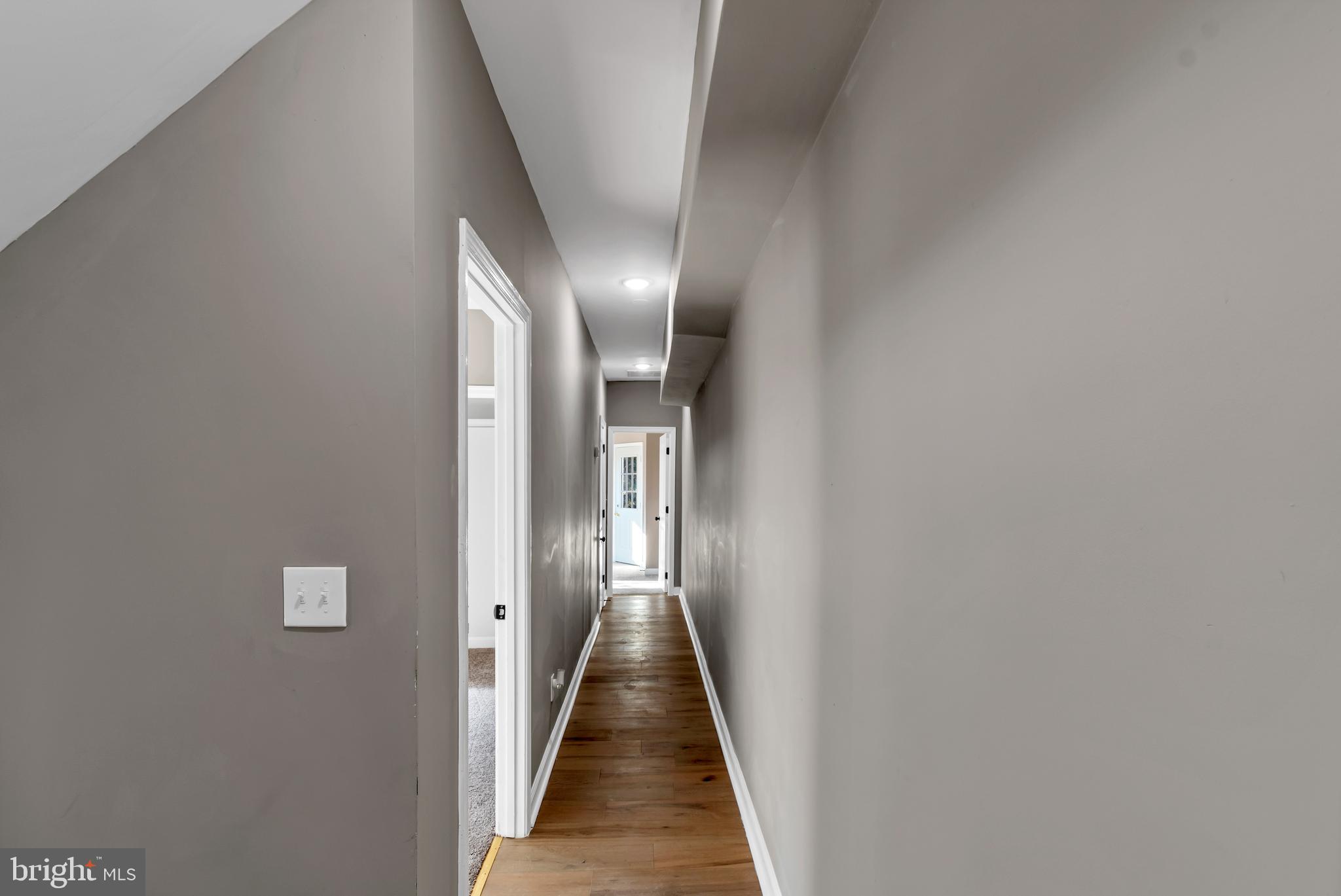 12 South Augusta Avenue Baltimore, MD 21229 - Photo 29 of 38 a view of a hallway with wooden floor