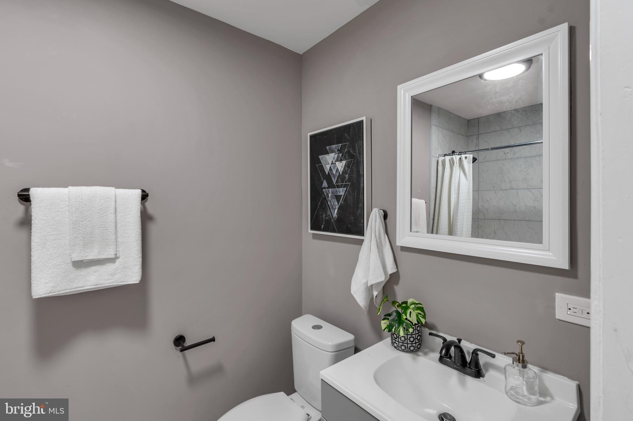 12 South Augusta Avenue Baltimore, MD 21229 - Photo 31 of 38 a bathroom with a toilet sink and mirror