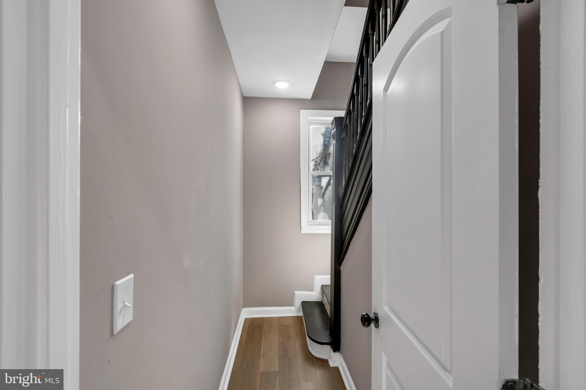 12 South Augusta Avenue Baltimore, MD 21229 - Photo 32 of 38 a view of a hallway with wooden floor and staircase