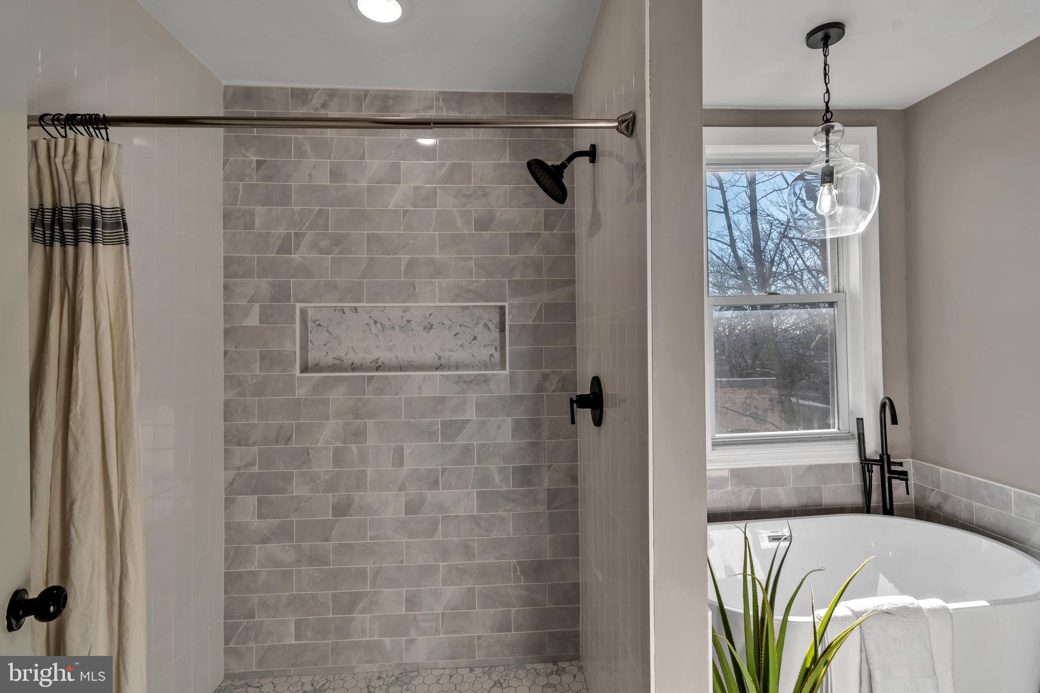 12 South Augusta Avenue Baltimore, MD 21229 - Photo 35 of 38 a bathroom with a bathtub and a shower