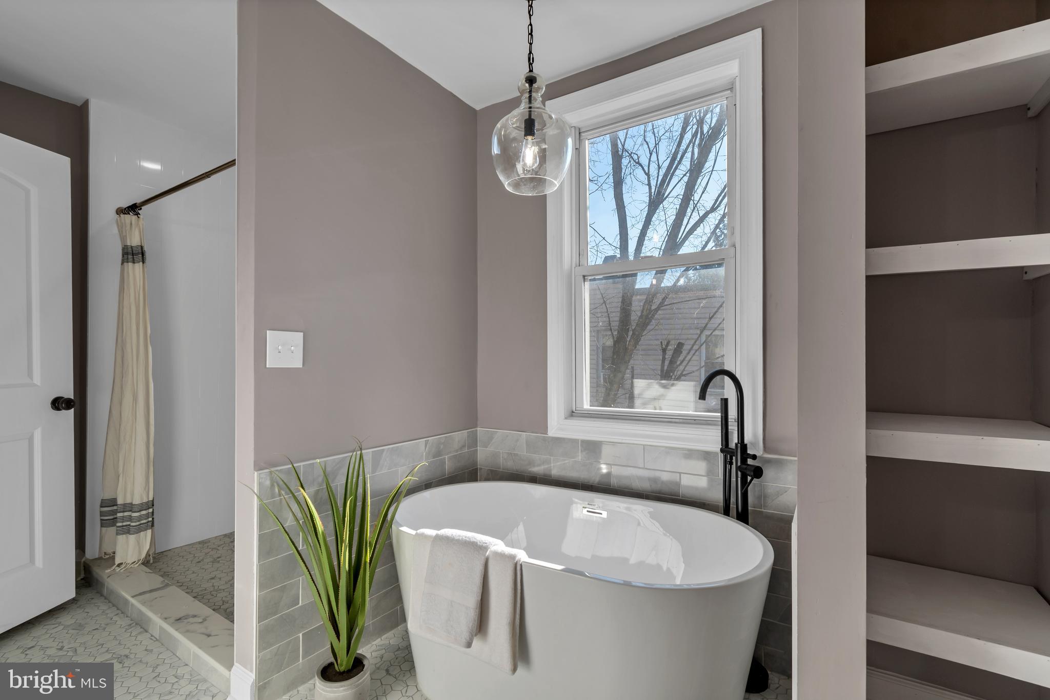 12 South Augusta Avenue Baltimore, MD 21229 - Photo 37 of 38 a bath tub sitting in a bathroom next to a window