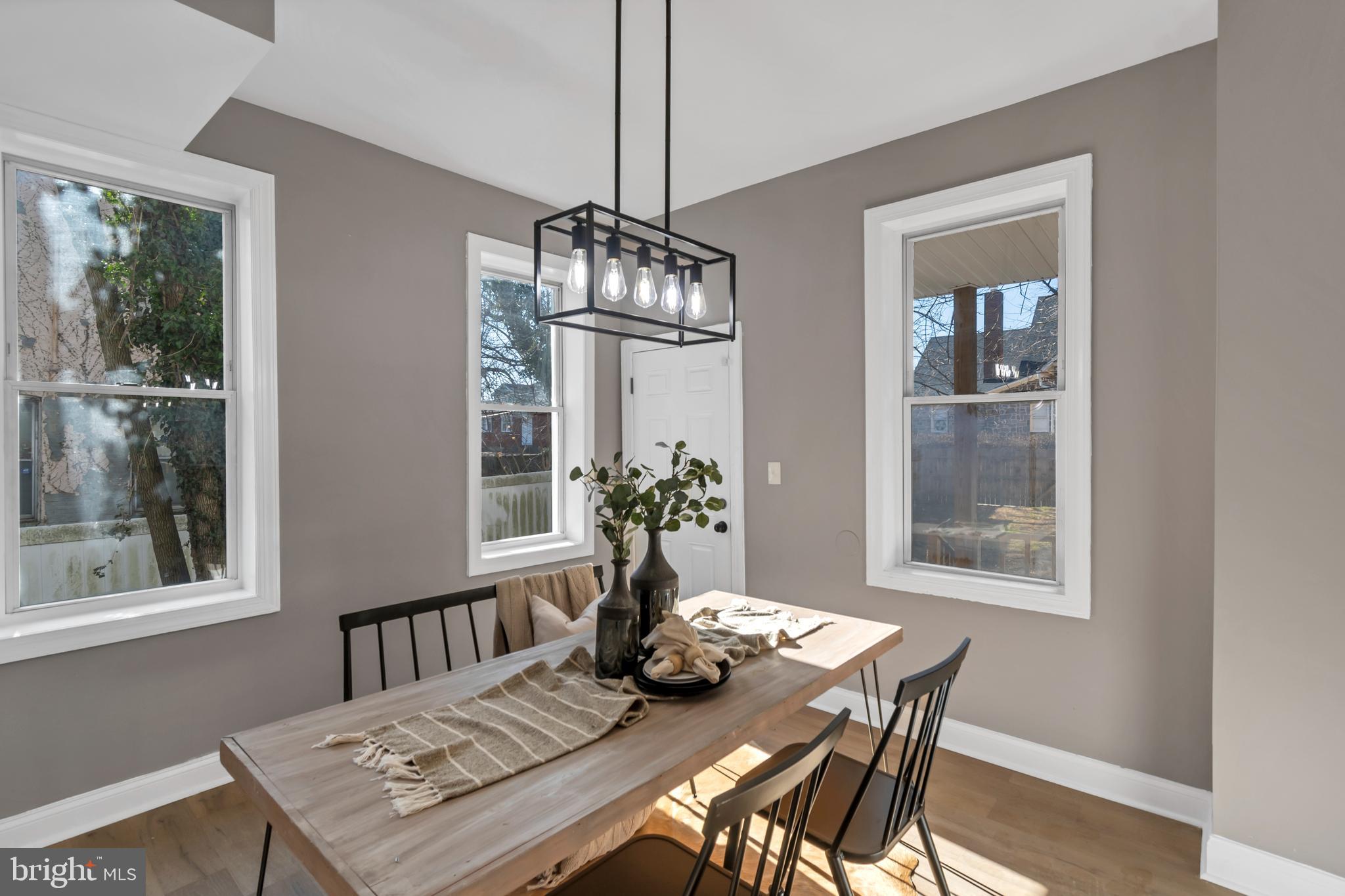 12 South Augusta Avenue Baltimore, MD 21229 - Photo 5 of 38 a view of a dining room with furniture window and wooden floor