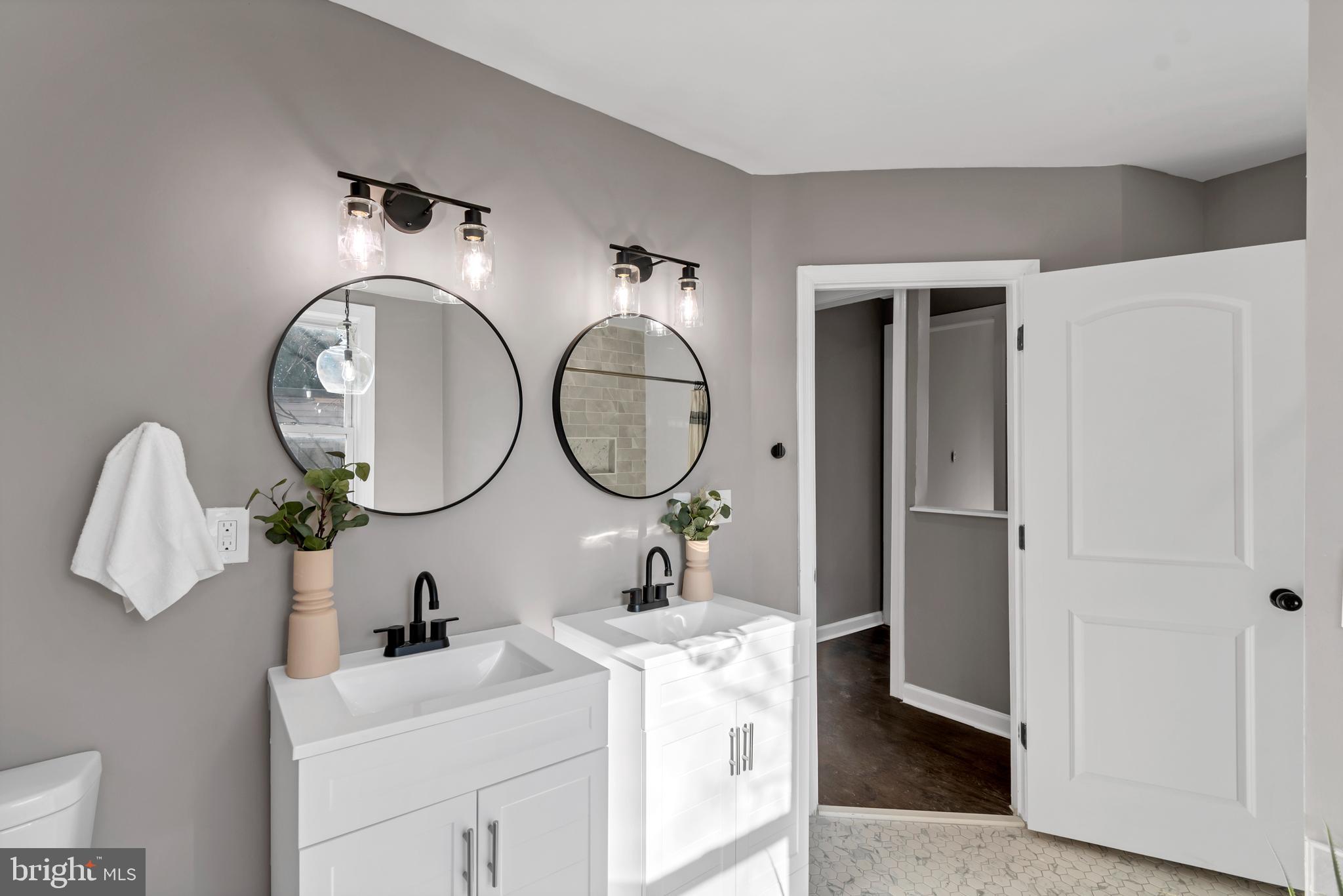 12 South Augusta Avenue Baltimore, MD 21229 - Photo 6 of 38 a bathroom with a sink and a mirror