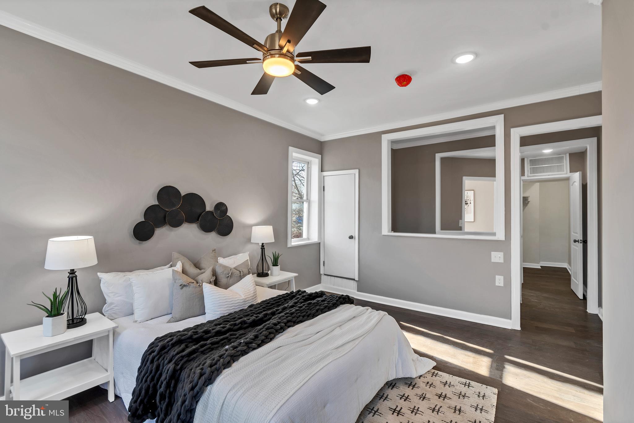 12 South Augusta Avenue Baltimore, MD 21229 - Photo 7 of 38 a bedroom with a bed and a chandelier